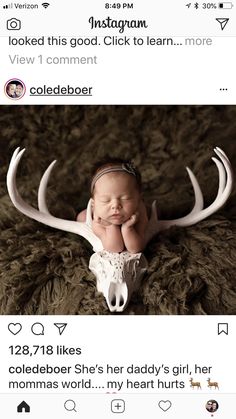 a baby laying on top of a fake antelope's head with the caption, i looked this good click to learn more