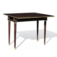 an old fashioned desk with gold trimmings on the top and legs, against a white background