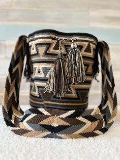 a brown and black bag sitting on top of a white carpet