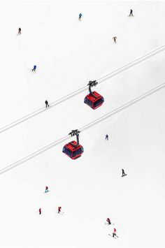 aerial view of skiers and snowboarders in the snow with ski lift on top