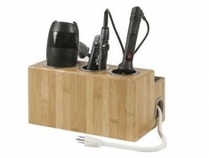 a wooden box with two electric gadgets and a hair dryer on it's side