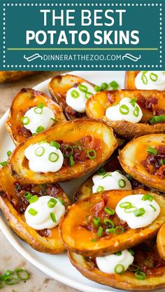 the best potato skins with sour cream on top and green onions in the middle, served on a white plate