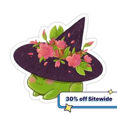 a green turtle wearing a purple witches hat with pink flowers on it's head