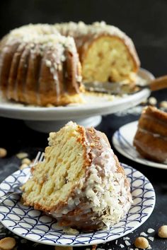 a bundt cake with frosting and nuts on a plate next to another bundt cake