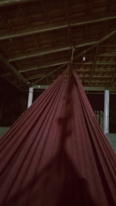 a large red hammock hanging from the ceiling