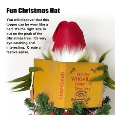 a christmas hat on top of a yellow book with red and white decorations around it