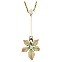 Here we have a truly beautiful early Art Nouveau necklace. This antique piece has been crafted from 15ct gold with a rounded natural pearl at the centre playing host a knife edge bar below which suspends a highly decorated, iconic Art Nouveau floral design. This ornate pendant is composed of beautifully enamelled leaves in muted green, yellow and pink with a delightful button pearl at the centre before a single round red ruby is found atop. This elegant piece sits on an matching 10ct gold chain. Condition: Used (Very Good) Weight: 6.6 grams Flower Dimensions: 18mm x 17mm x 2mm Bar Length: 22mm Pearl Dimensions: 1 (4mm), 1 (3mm) Ruby Dimensions: 1.5mm Chain Length: 17 inches Chain Width: 1.5mm Fastening: Bayonet Clasp Marked: '15c' & '10' Period: Early Art Nouveau (Circa. 1890s) Box: Plain Conch Pearl, Art Nouveau Necklaces, Art Nouveau Flowers, Art Nouveau Pendant, Iconic Art, Muted Green, Art Nouveau Floral, Necklace Art, Pendant Watches