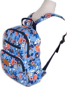 a blue backpack with flowers on it and a white back pack hanging from the front