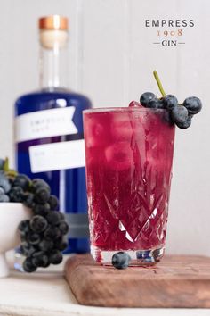 Pictured: the Empress Elixir cocktail, with a deep ruby-red hue, and cascading garnish of concord grapes. Fun Beverages, Empress Gin, Empress 1908 Gin, Sweet And Spooky, Pretty Alcoholic Drinks, Gin Drinks, Cocktail Serving, Sour Cocktail