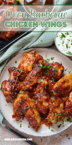 chicken wings on a plate with sauce and parsley in the background text reads oven barbecue chicken wings