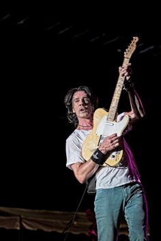 a man playing an electric guitar on stage