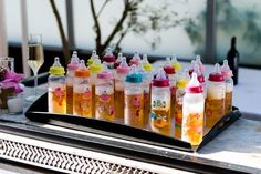 many baby bottles are lined up on a tray