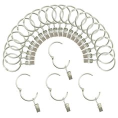 six pairs of silver hoop earrings with clips on each end and two hooks in the middle