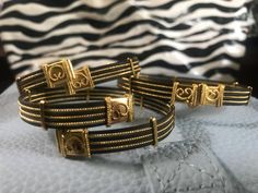 This is a group of vintage NEW OLD STOCK unused FAUX elephant hair bracelets. The metal is 24 karat gold plate. These bracelets close with a very simple hook closure. Shipping and handling and insurance is free!  USA bidders only please. I have three of the style bracelet right now. They are all slightly different in size. So when you buy one please choose the dimensions you wish These are the dimensions IN INCHES  taken by the diameter one way horizontally and then vertically. 1 2.75×2.25 INCHE Elephant Bracelet Gold, Elephant Hair Bangle Gold, Elephant Hair Jewelry, Elephant Hair Bracelet, Elephant Hair, Hair Bracelet, Elephant Bracelet, 24 Karat Gold, Gold Plated Bangles