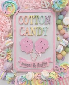 cotton candy sign surrounded by candies and lollipops in pastel colors