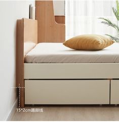 a bed with two drawers underneath it and a pillow on top of the mattresses