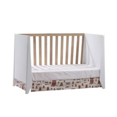 a wooden crib with a white sheet on the bottom and brown trim around it