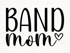 the word band mom is written in black ink on a white wood background with a heart