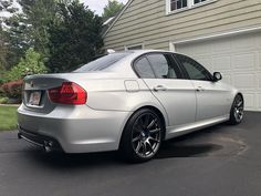 a silver car parked in front of a house