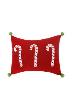 a red pillow with candy canes on it