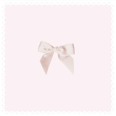 a white bow on a pink background