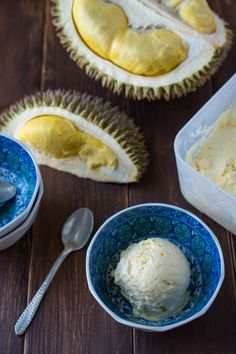 two bowls filled with ice cream next to each other on top of a wooden table