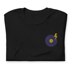 This t-shirt style features a "wear to spin vinyl" across the back and embroidered vinyl record at the left chest as a nod to the art of vinyl music.  It feels soft and lightweight, with the perfect amount of stretch.  It's comfortable and flattering for all.  Take your true size. * 100% combed and ring-spun cotton (Heather colors contain polyester) * Fabric weight: 4.2 oz./yd.² (142 g/m²) * Pre-shrunk fabric * Side-seamed construction * Shoulder-to-shoulder taping * Blank product sourced from N Fitted Black Music-themed T-shirt, Black Fitted Music-themed T-shirt, Unisex Crew Neck T-shirt With Heat Transfer Vinyl, Black T-shirt With Heat Transfer Vinyl Band Merch, Vinyl Music, T Shirt Style, Vinyl Record, Nicaragua, Honduras