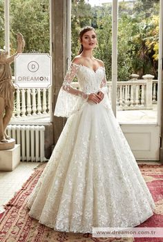 a woman in a white wedding dress posing for the camera