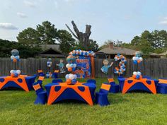 an outdoor party with blue and orange decorations