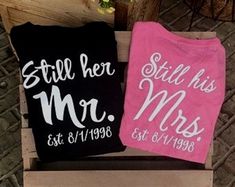 two t - shirts that say still her and mr and mrs on them sitting next to each other