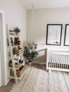 a baby's room with a white crib and lots of pictures on the wall