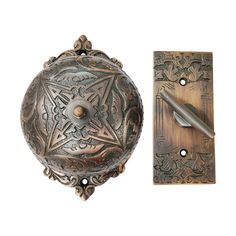 an ornate door handle with a pen resting on it next to a decorative doorknob