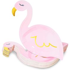 a pink flamingo shaped paper plate sitting on top of stacks of cards with yellow eyes