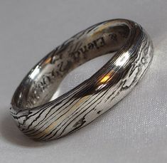 a silver ring with writing on it