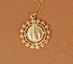 Virgin mary necklace - religious necklace - catholic necklace - a tiny gold virgin mary on a 14k gold vermeil chain This tiny 22k gold vermeil virgin mary crest hangs on a 16 inch 14k gold vermeil chain. Please feel free to select a different length chain if you prefer. Now available in sterling silver! The pendant measures: 16mm Looking for other charm necklaces? https://www.etsy.com/shop/BubuRuby?section_id=12318467 More crystals and healers? http://www.etsy.com/shop/BubuRuby?section_id=130735 Gold Virgin Mary Medallion Charm, Gold Virgin Mary Medallion Jewelry, Gold Virgin Mary Medallion, Gold Medallion With Virgin Mary, Gold Medallion Necklace, Mary Necklace, Catholic Necklace, Virgin Mary Necklace, Gold Medallion