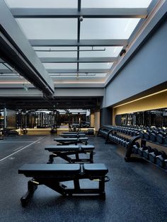 an empty gym with rows of black benches