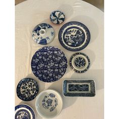 blue and white plates are arranged on a table