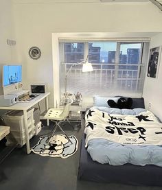 a bed room with a neatly made bed and a desk in front of a window