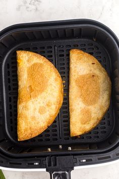 two pieces of bread sitting in an air fryer