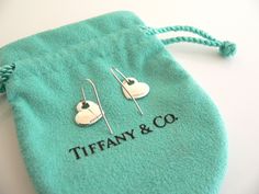 Overview:Time to pull your hair back and show off your awesome earrings! Offered for sale is a gorgeous and elegant pair of Tiffany and Co. Sterling Silver Double Heart Dangling earrings. This pair looks fabulous, cosmopolitan, and yet retains a very dainty and feminine touch to it. Extremely elegant and comfortable piece! You will feel playful, modern and super stylish while wearing these earrings. Great pair to wear for work, a night in town, at a party, or just going to dinner with friends in