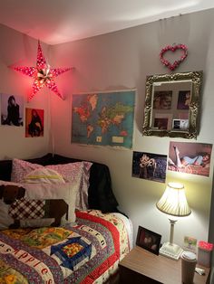 a bed room with a neatly made bed and pictures on the wall