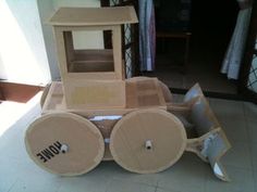 a cardboard construction vehicle sitting on the floor