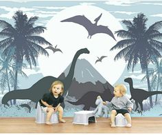 two children sitting on stools in front of a wall with dinosaurs and palm trees