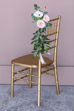 a gold chair with flowers on the back