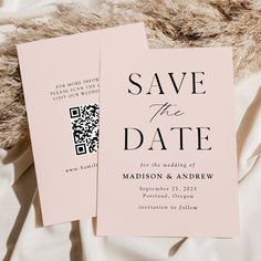 two pink wedding save the dates cards with qr code on them sitting on a bed