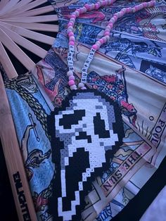 an image of a fan with a skull on it's side and some other items in the background