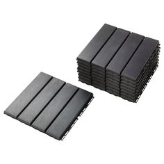 several black tiles stacked on top of each other in front of a white background,