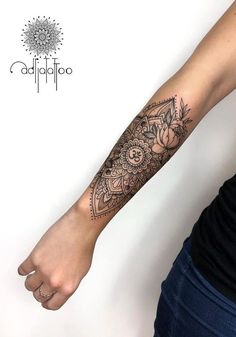 a woman's arm with a tattoo on it and flowers in the middle of her arm