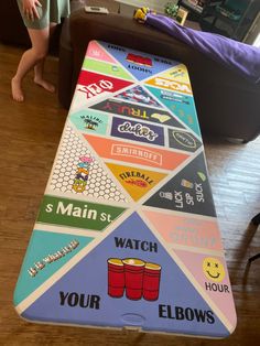 a child standing in front of a large board with different types of games on it