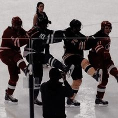 some people are playing ice hockey on an ice rink